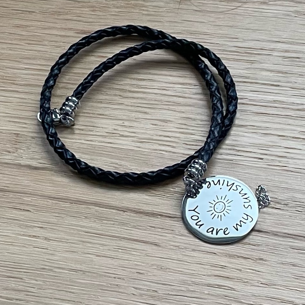 Balla black woven bracelet with charm.